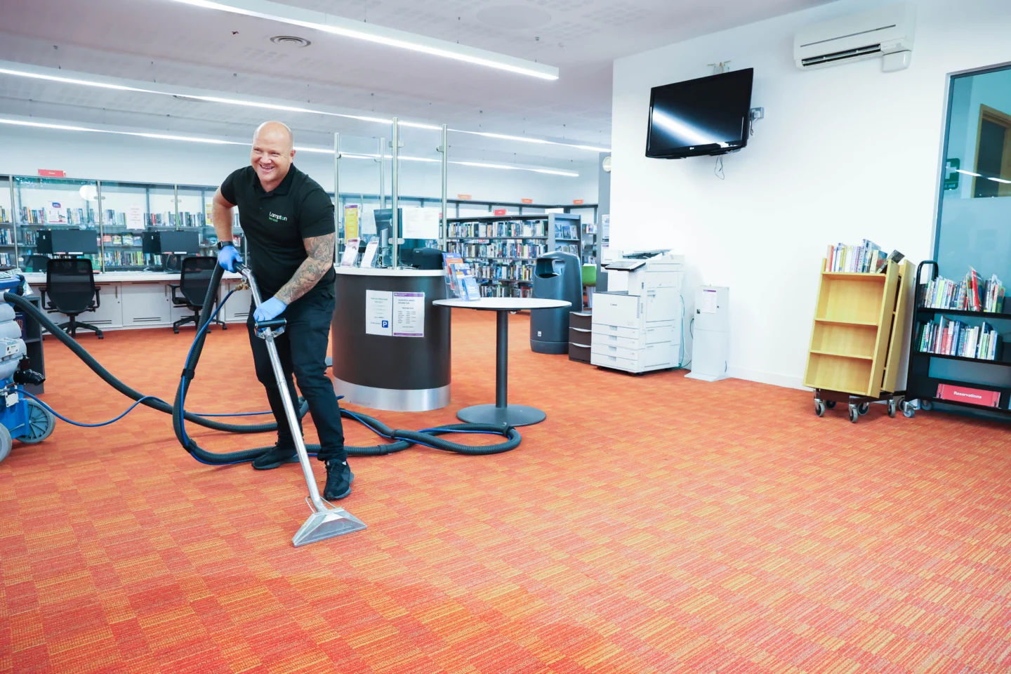 Person cleaning a floor with a hoover