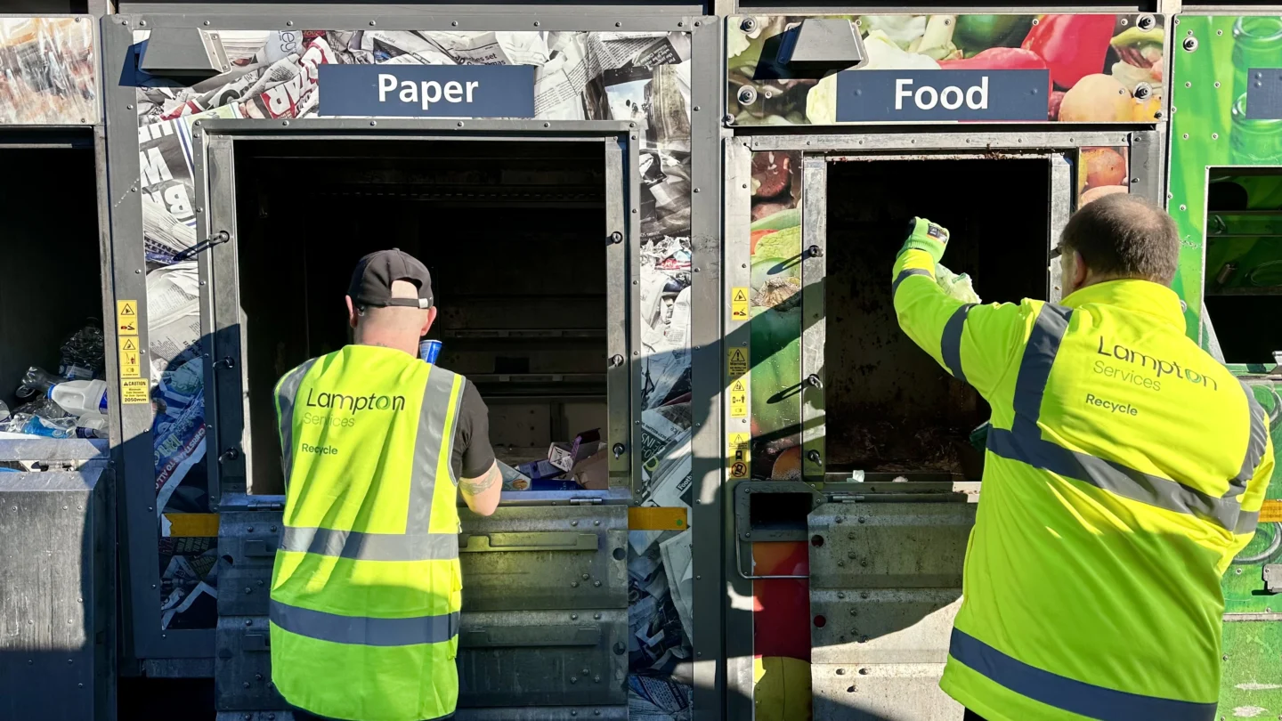 Two men recycling paper and food